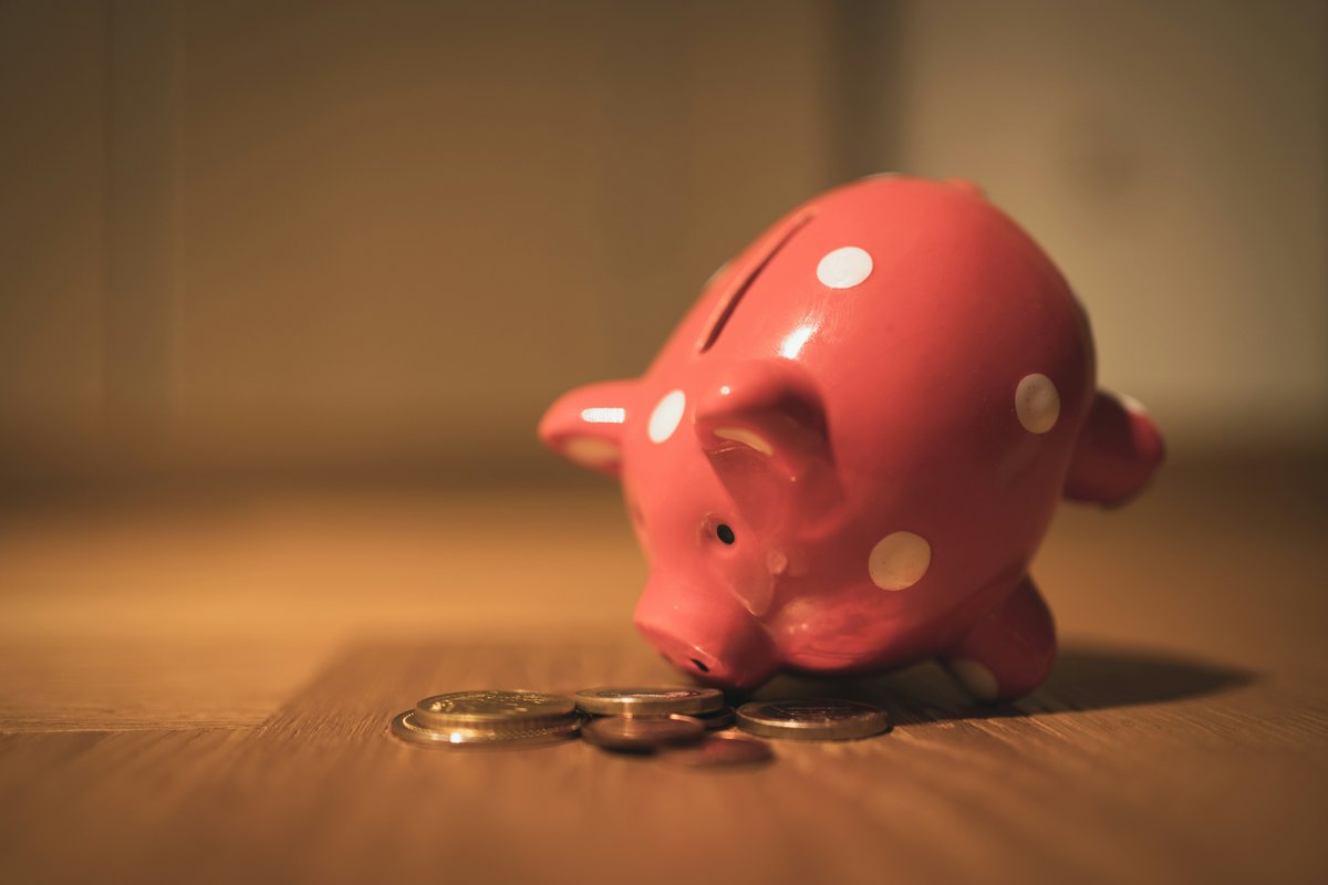 Piggy bank with coins strewn around